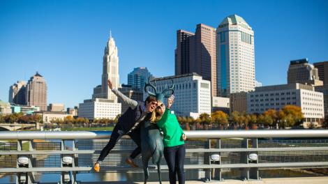 Posing with the deer sculpture in front of the city skyline on the Scioto Mile Posing with the deer sculpture in front of the city skyline on the Scioto Mile