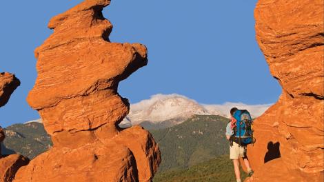 Hiker at Siamese Twins rock formation at Garden of the Gods, Colorado Hiker at Siamese Twins rock formation at Garden of the Gods, Colorado
