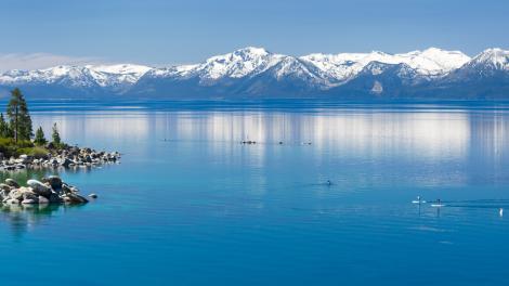 Snow-capped Sierra Nevada mountains frame Lake Tahoe’s Emerald Bay