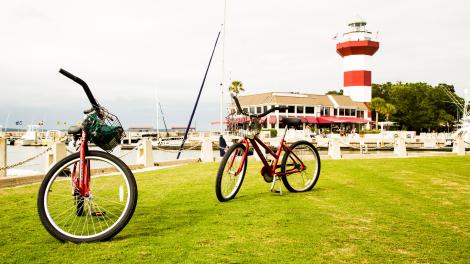 Biking in front of The Harbour Town Lighthouse in Hilton Head Island, South Carolina Biking in front of The Harbour Town Lighthouse in Hilton Head Island, South Carolina