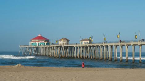 Yoga in the sand at the Huntington Beach Pier in California Yoga in the sand at the Huntington Beach Pier in California