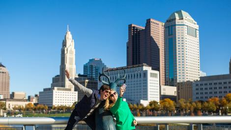 Posing with the deer sculpture in front of the city skyline on the Scioto Mile Posing with the deer sculpture in front of the city skyline on the Scioto Mile