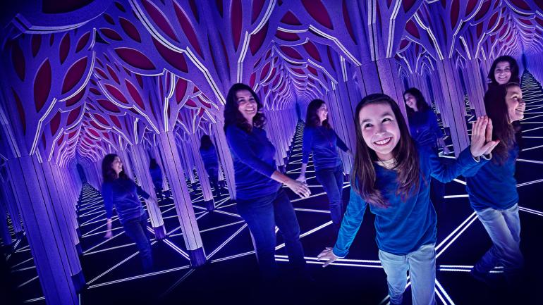 正在科学与工业博物馆内探索穿越镜子迷宫的参观者