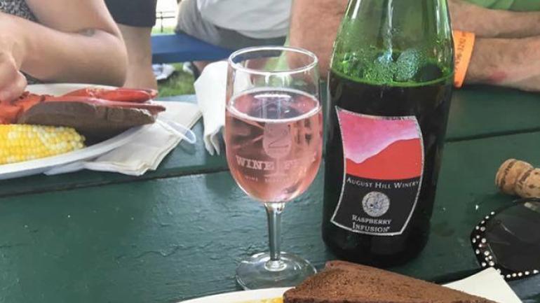 Sampling August Hill Winery’s Raspberry Infusion wine at the 2 Rivers Wine Fest Sampling August Hill Winery’s Raspberry Infusion wine at the 2 Rivers Wine Fest