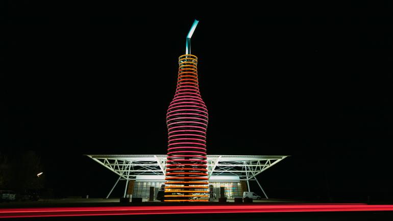 夜色中,俄克拉荷马州阿卡迪亚 Pops 66 Soda Ranch 餐厅外的巨型发光苏打水瓶雕塑 夜色中,俄克拉荷马州阿卡迪亚 Pops 66 Soda Ranch 餐厅外的巨型发光苏打水瓶雕塑