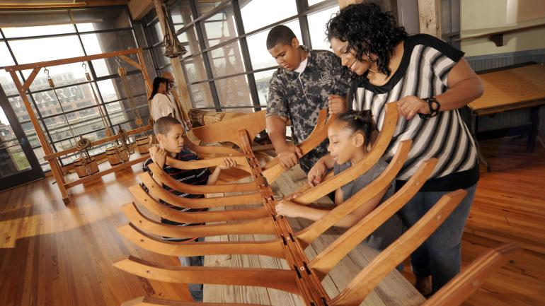 A family enjoys a hands-on exhibit at the Frederick Douglass Isaac Myers Maritime Park A family enjoys a hands-on exhibit at the Frederick Douglass Isaac Myers Maritime Park