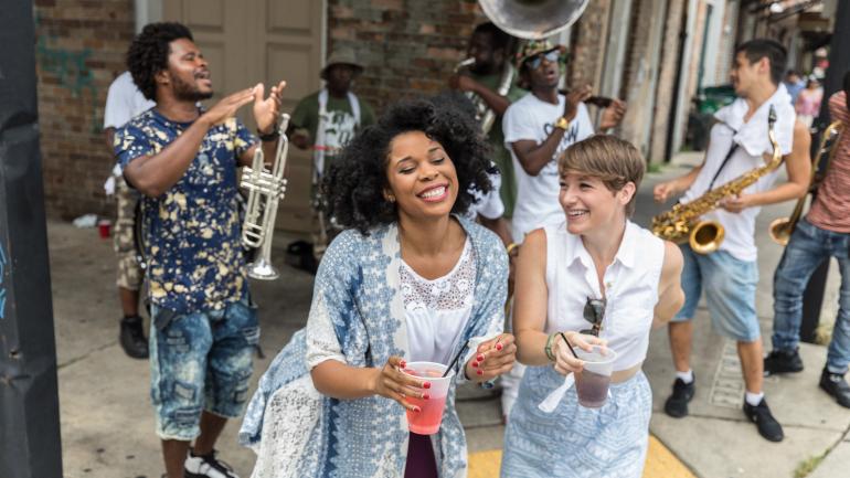A pair of women enjoy the street musicians on French Street