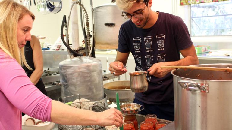 游客忘我地在布朗斯维尔小石城罐头厂制作果酱罐头