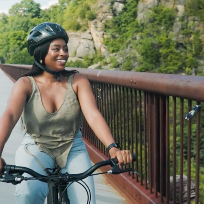 Cyclist crossing a bridge while exploring upstate New York