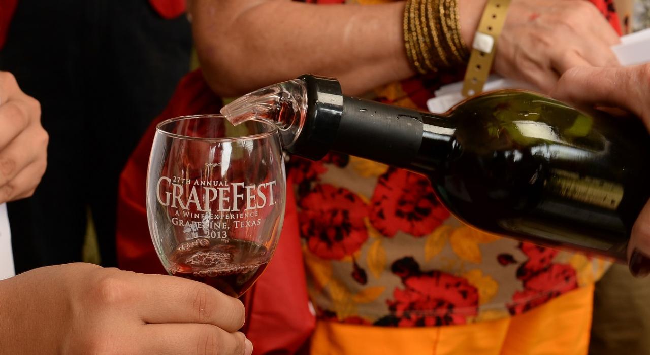 Pouring wine at Grapefest Texas Festival