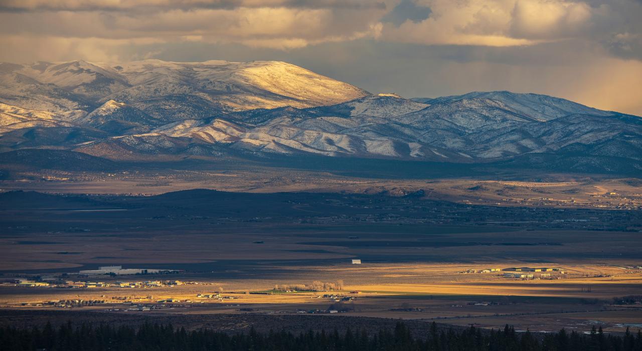 Sunset casting shadows over the mountains surrounding the city