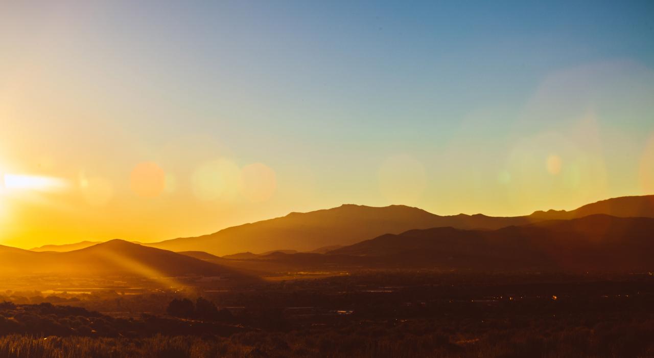 Golden sunrise with rays of light touching the high desert area