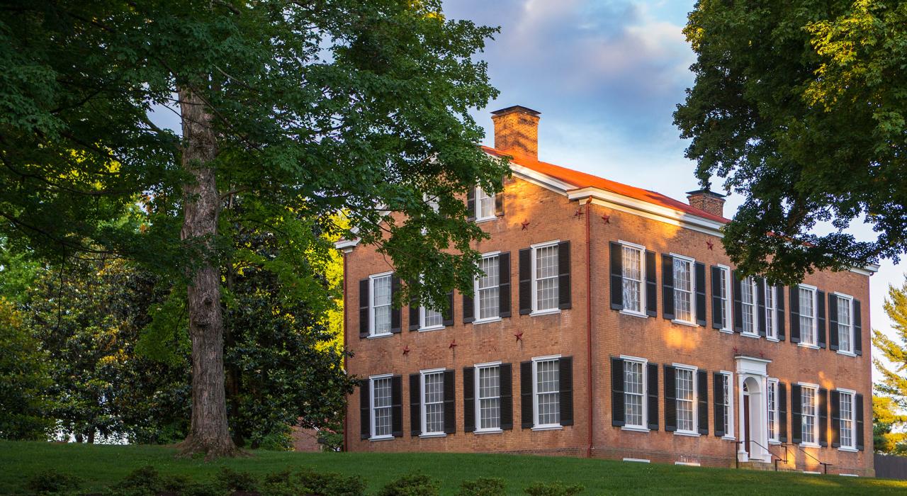 The manicured grounds and stately mansion of My Old Kentucky Home State Park